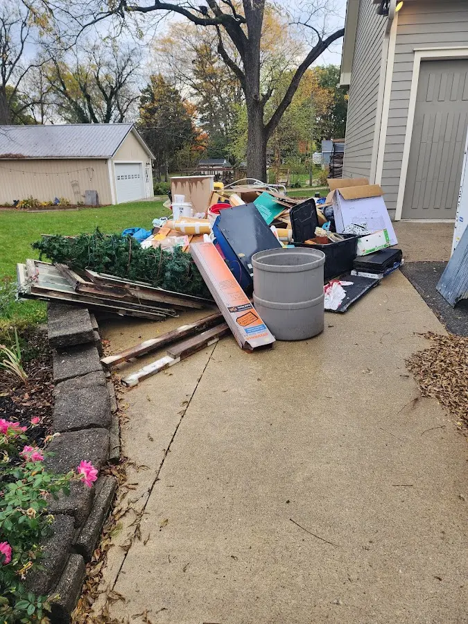 Dumpster being loaded with debris for Estate Cleanout Dumpster Rental in Winterville